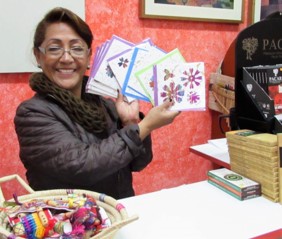 Our shop in Ecuador. A volunteer holding handmade cards