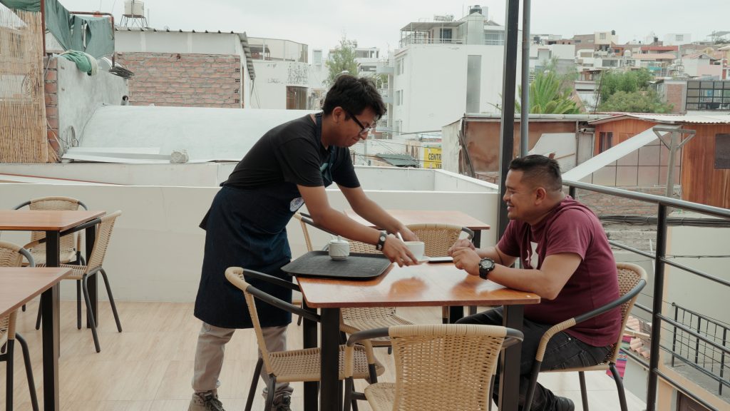 2 trainees sitting outside in Peru
