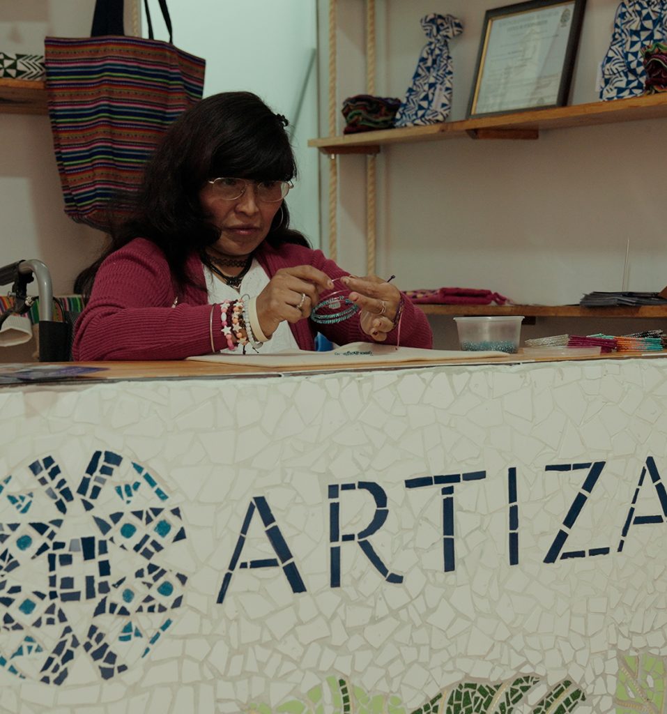 A lady making jewellery at Artizan Peru